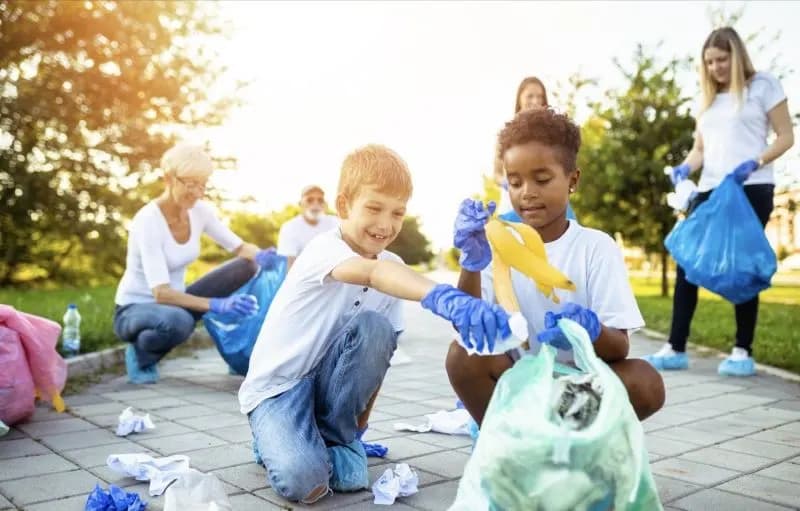 Young volunteers litter-picking in a park